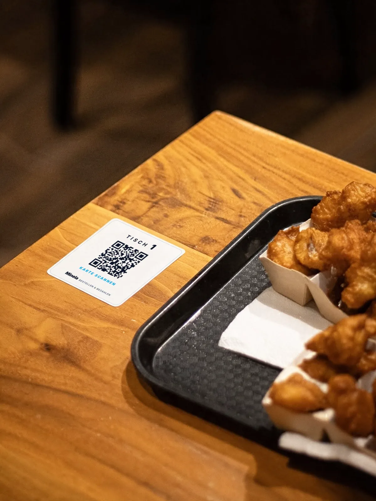 Minela QR table card on the wooden table – table 1, scan the card
